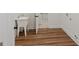 Dedicated laundry room with utility sink, wood look flooring and white trim at 4585 Parkwood Rd, Social Circle, GA 30025