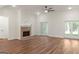 Large living room with a brick fireplace and double glass doors that open to the outdoors at 4585 Parkwood Rd, Social Circle, GA 30025