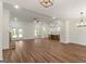 Spacious living room with hardwood floors, fireplace, and seamless flow to the kitchen at 4585 Parkwood Rd, Social Circle, GA 30025