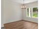 Bright dining room features wood floors, modern lighting, and windows with scenic views at 4585 Parkwood Rd, Social Circle, GA 30025