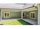 Covered outdoor patio with ceiling fan and multiple entry doors to the house at 4585 Parkwood Rd, Social Circle, GA 30025