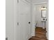 Charming powder room with hardwood floors, pedestal sink, and black hardware at 4585 Parkwood Rd, Social Circle, GA 30025