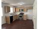 Functional kitchen featuring stainless steel appliances, wood cabinets, and durable countertops at 6372 Stonebridge Creek Ln, Lithonia, GA 30058