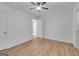 This bright bedroom features modern ceiling fan and new floors at 1834 Stroud Road, Mcdonough, GA 30252