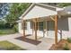 Close-up of home's covered front porch with natural wooden supports and fresh landscaping at 1834 Stroud Road, Mcdonough, GA 30252