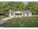 Charming single story home with a manicured lawn, brick facade, and inviting front porch at 1834 Stroud Road, Mcdonough, GA 30252