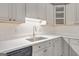 Bright kitchen features white countertops and cabinets, undermount lighting, and black dishwasher at 1834 Stroud Road, Mcdonough, GA 30252