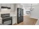 Modern kitchen featuring white cabinets, black appliances, and wood-look flooring at 1834 Stroud Road, Mcdonough, GA 30252