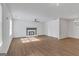 Spacious living room with wood flooring, fireplace, ceiling fan, and modern lighting at 1834 Stroud Road, Mcdonough, GA 30252