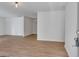 Open living area with wood flooring and white walls leading to adjoining rooms at 1834 Stroud Road, Mcdonough, GA 30252