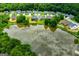 Aerial view of lake with houses and green trees in a residential area at 328 Brookstone Dr, Carrollton, GA 30116