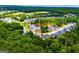 Aerial community view highlighting lake, houses, and surrounding green trees at 328 Brookstone Dr, Carrollton, GA 30116
