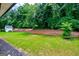 Large backyard with green grass and a white storage shed at 328 Brookstone Dr, Carrollton, GA 30116