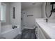 Bright bathroom with soaking tub, tiled shower, and gray wood-look tile flooring at 328 Brookstone Dr, Carrollton, GA 30116