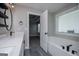 Bright bathroom featuring a soaking tub, double vanity, and access to the primary bedroom at 328 Brookstone Dr, Carrollton, GA 30116