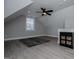 Bonus room with grey walls, black ceiling fan, grey rug and accent furnishings at 328 Brookstone Dr, Carrollton, GA 30116