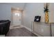 Entryway with gold console table, wood flooring, and a white front door with glass panel at 328 Brookstone Dr, Carrollton, GA 30116