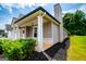 Home exterior featuring manicured lawn, chimney, a covered porch with brick at 328 Brookstone Dr, Carrollton, GA 30116