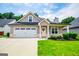 Charming single Gathering home featuring an attached two-car garage and manicured front lawn at 328 Brookstone Dr, Carrollton, GA 30116