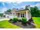 Home exterior featuring manicured lawn, chimney, a covered porch with brick and a two car garage at 328 Brookstone Dr, Carrollton, GA 30116