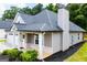 Home exterior featuring manicured lawn, chimney, a covered porch with brick and a two car garage at 328 Brookstone Dr, Carrollton, GA 30116