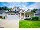 Charming single Gathering home featuring an attached two-car garage and manicured front lawn at 328 Brookstone Dr, Carrollton, GA 30116