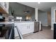 Open kitchen features stainless steel appliances, white cabinets and connects to the living area at 328 Brookstone Dr, Carrollton, GA 30116
