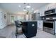 Modern kitchen with stainless steel appliances, breakfast bar, and open to the dining room at 328 Brookstone Dr, Carrollton, GA 30116