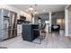 Well-equipped kitchen with white cabinets, stainless steel appliances, island, and open layout to living room at 328 Brookstone Dr, Carrollton, GA 30116