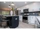 Contemporary kitchen with marble countertops, stainless steel appliances, and black herringbone backsplash at 328 Brookstone Dr, Carrollton, GA 30116