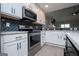 Stylish kitchen featuring stainless steel appliances, marble countertops, and white cabinetry at 328 Brookstone Dr, Carrollton, GA 30116