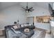 Open-concept living room featuring vaulted ceilings, modern fan, and seamless flow into kitchen at 328 Brookstone Dr, Carrollton, GA 30116