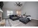 Comfortable living room showcases a large gray sectional sofa and large window for natural light at 328 Brookstone Dr, Carrollton, GA 30116