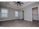 Spacious bedroom with tray ceilings, ceiling fan, and a view of the walk-in closet at 328 Brookstone Dr, Carrollton, GA 30116