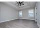 Bright bedroom featuring tray ceilings, ceiling fan, and large windows for ample natural light at 328 Brookstone Dr, Carrollton, GA 30116