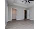 Bright bedroom featuring tray ceilings, ceiling fan, and multiple walk-in closet access at 328 Brookstone Dr, Carrollton, GA 30116