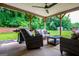 Covered back patio with wicker furniture set and grill overlooking backyard at 328 Brookstone Dr, Carrollton, GA 30116