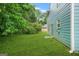 Fenced backyard with well-maintained lawn, mature trees, and blue siding at 4753 Klondike Cv, Lithonia, GA 30038