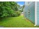 Fenced backyard with well-maintained lawn, mature trees, and blue siding at 4753 Klondike Cv, Lithonia, GA 30038