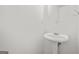 Compact bathroom featuring a pedestal sink, mirror, and modern fixtures at 4753 Klondike Cv, Lithonia, GA 30038