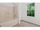 Bright bathroom featuring a tub/shower combination and natural light from the window at 4753 Klondike Cv, Lithonia, GA 30038