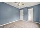 This freshly painted bedroom features carpeted floors and blue walls at 4753 Klondike Cv, Lithonia, GA 30038