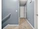 Upstairs hallway with neutral carpet, blue walls, and white doors at 4753 Klondike Cv, Lithonia, GA 30038