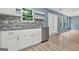 Bright kitchen features white cabinets, stainless steel appliances, granite countertops, and a stylish tile backsplash at 4753 Klondike Cv, Lithonia, GA 30038