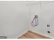 Bright laundry closet with hookups, shelving, and wood-look floors at 4753 Klondike Cv, Lithonia, GA 30038