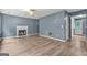 Spacious living room with fireplace and wood-look floors. Door to the right of the fireplace at 4753 Klondike Cv, Lithonia, GA 30038