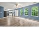 Spacious living room featuring an open floor plan, wood-look flooring, ample natural light, and stylish design at 4753 Klondike Cv, Lithonia, GA 30038