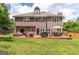 Spacious home exterior with a large deck, perfect for outdoor gatherings and enjoying the expansive green lawn at 130 Bexar Ct, Johns Creek, GA 30022