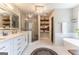 Bright bathroom with double sinks, a walk-in shower, soaking tub, and stylish tile flooring at 130 Bexar Ct, Johns Creek, GA 30022