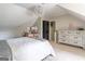 Charming bedroom featuring sloped ceilings, a chandelier, and a cozy bed with decorative accents at 130 Bexar Ct, Johns Creek, GA 30022